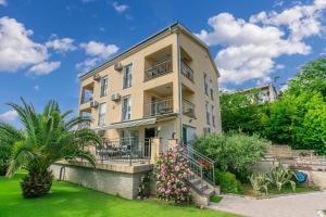 an apartment building with a balcony and flowers at Dolores in Crikvenica