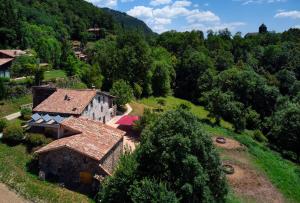 an aerial view of a house on a hill at Casa Rural "Can Soler de Rocabruna" Camprodon in Rocabruna