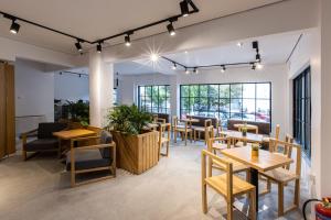 a restaurant with tables and chairs and windows at Saint George Boutique Rooms in Komotini