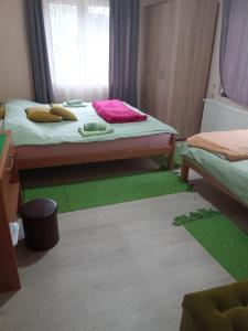a bedroom with a bed with a green rug and a window at Valja Mare Moma in Golubac