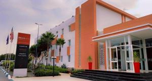 um edifício com um sinal em frente em Relax Hotel Kenitra em Kenitra