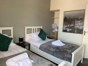 Ліжко або ліжка в номері The Kensingston - Quaint Victorian Home With Free Parking