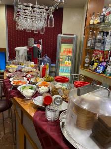 a table with many dishes of food on it at Eurohotel Central in Yekaterinburg