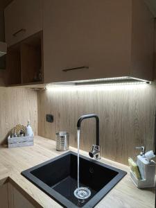 a kitchen sink with a faucet on a counter at Casa Lilla&Fabry Olbia in Olbia