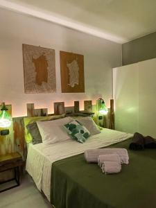 a bedroom with a large bed with two towels on it at Casa Lilla&Fabry Olbia in Olbia