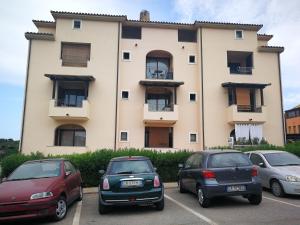 a building with cars parked in front of it at Casa Lilla&Fabry Olbia in Olbia