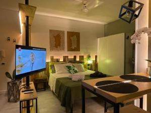 a bedroom with a bed and a television in it at Casa Lilla&Fabry Olbia in Olbia