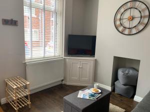 ヨークにあるThe Kensingston - Quaint Victorian Home With Free Parkingのリビングルーム(テレビ、椅子付)