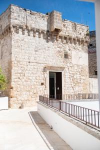 a large brick building with a door in it at Arya Nobile Dimora in Carovigno