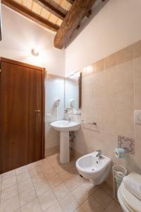 a bathroom with a sink and a toilet at Albergo La Loggia di San Martino in Gualdo Tadino