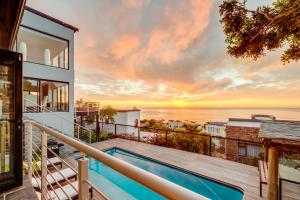 a view of the ocean from a house with a swimming pool at Sunset Views in Cape Town