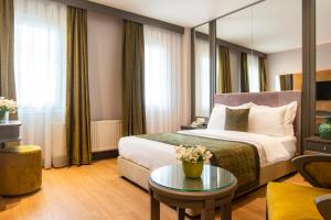 a hotel room with a bed and a table at Oran Hotel in Istanbul