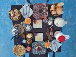 a table topped with plates of food and drinks at Casa El Haouta in Chefchaouen