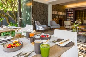 a table with food and drinks on top of it at Kensington Place in Cape Town