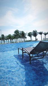 un banco sentado en el agua con árboles en el fondo en Riviera Beach Place - Aquiraz Riviera, en Fortaleza