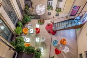 einen Blick über den Garten in einem Gebäude mit Tischen und Stühlen in der Unterkunft Maison Roma Piazza di Spagna UNA Esperienze in Rom