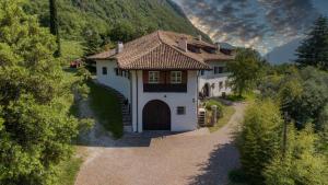 a small white house with a brown roof at Vallarom in Avio