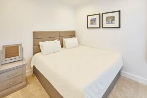 a bedroom with a white bed and a tv at Host & Stay - One Love in Harrogate