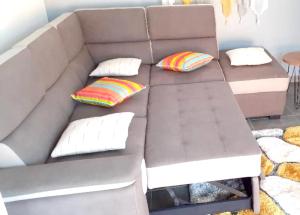 a gray couch with pillows and a table at Maison charmante à Sainte-Anne in Sainte-Anne +13 photos