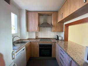 A kitchen or kitchenette at Amazing duplex with large terrace and sea views
