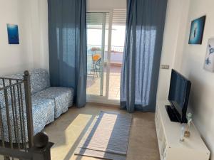 A television and/or entertainment centre at Amazing duplex with large terrace and sea views