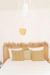 un letto con lenzuola e cuscini bianchi in una camera da letto di 7 en Arles a Arles