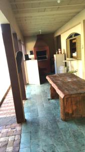 a kitchen with a wooden table and a refrigerator at Hostel Park in Uberlândia