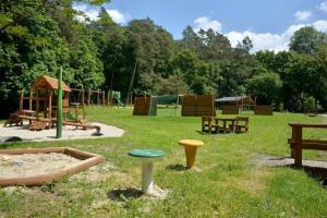 a park with a playground with a sandbox and a play area at Irma- forrás Vendégházak in Kismaros