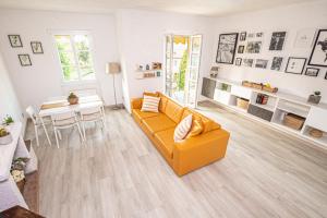 a living room with a yellow couch and a table at SARA E MELISSA HOUSE LIERNA in Lierna