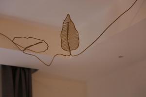 a drawing of two leaves on a ceiling at Old Town Home Trastevere in Rome