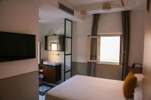 a hotel room with a bed and a television at Old Town Home Trastevere in Rome