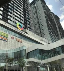 a large building with a sign on the side of it at KL Gateway Premium Residence I HomeBrickz in Kuala Lumpur