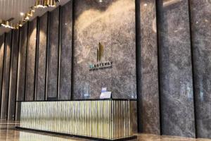 a lobby with a wall with a sign on it at KL Gateway Premium Residence I HomeBrickz in Kuala Lumpur