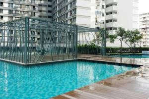 a swimming pool with a cage in the middle of a building at KL Gateway Premium Residence I HomeBrickz in Kuala Lumpur