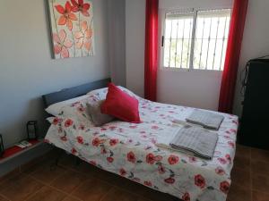 a small bedroom with a bed with red curtains at CASA BELLA in Los Altos +27 photos