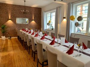 rzędu stołów w pokoju z czerwonymi serwetkami w obiekcie Hotel & Restaurant Wiggers w mieście Bad Oldesloe