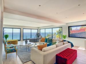 a living room with a couch and a table at Villa Bahari by LovelyStay in Caniçal