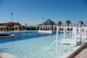 a pool with a white chair in the water at Goldenburg Residence in Plovdiv