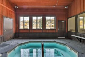 a hot tub in a room with windows at Brian Head Condo with Patio and Community Amenities! in Brian Head