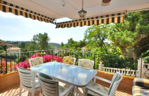 a patio with a table and chairs on a balcony at Villa Dolcedo in Lloret de Mar