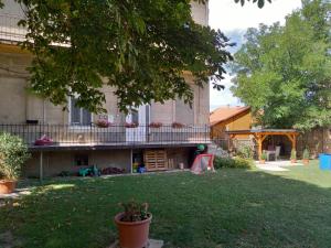 a yard with a house with a playground in front of it at Elizabeth Apartman in Makó