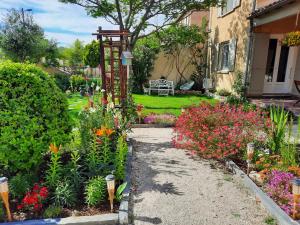 un jardin avec des fleurs colorées et une maison dans l'établissement La Maison du Chemin des Prairies, à Morières-lès-Avignon 16 autres photos