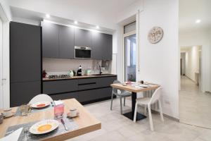 a kitchen and dining room with a table and chairs at L'isola che c'è in Cagliari