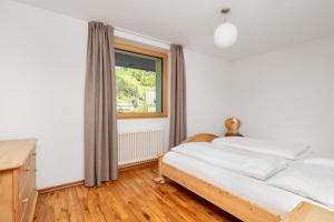 Łóżko lub łóżka w pokoju w obiekcie Residence Catarina Lanz