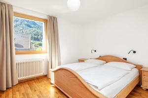 Łóżko lub łóżka w pokoju w obiekcie Residence Catarina Lanz