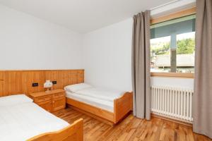 Łóżko lub łóżka w pokoju w obiekcie Residence Catarina Lanz