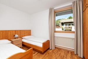 Łóżko lub łóżka w pokoju w obiekcie Residence Catarina Lanz