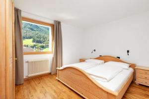 Łóżko lub łóżka w pokoju w obiekcie Residence Catarina Lanz