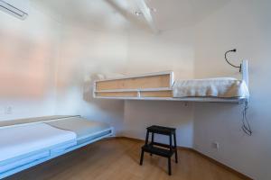 a small room with a bunk bed and a stool at Quinta da Bicuda in Cascais