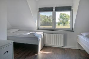 Posteľ alebo postele v izbe v ubytovaní Apartamenty Zielona Lipka